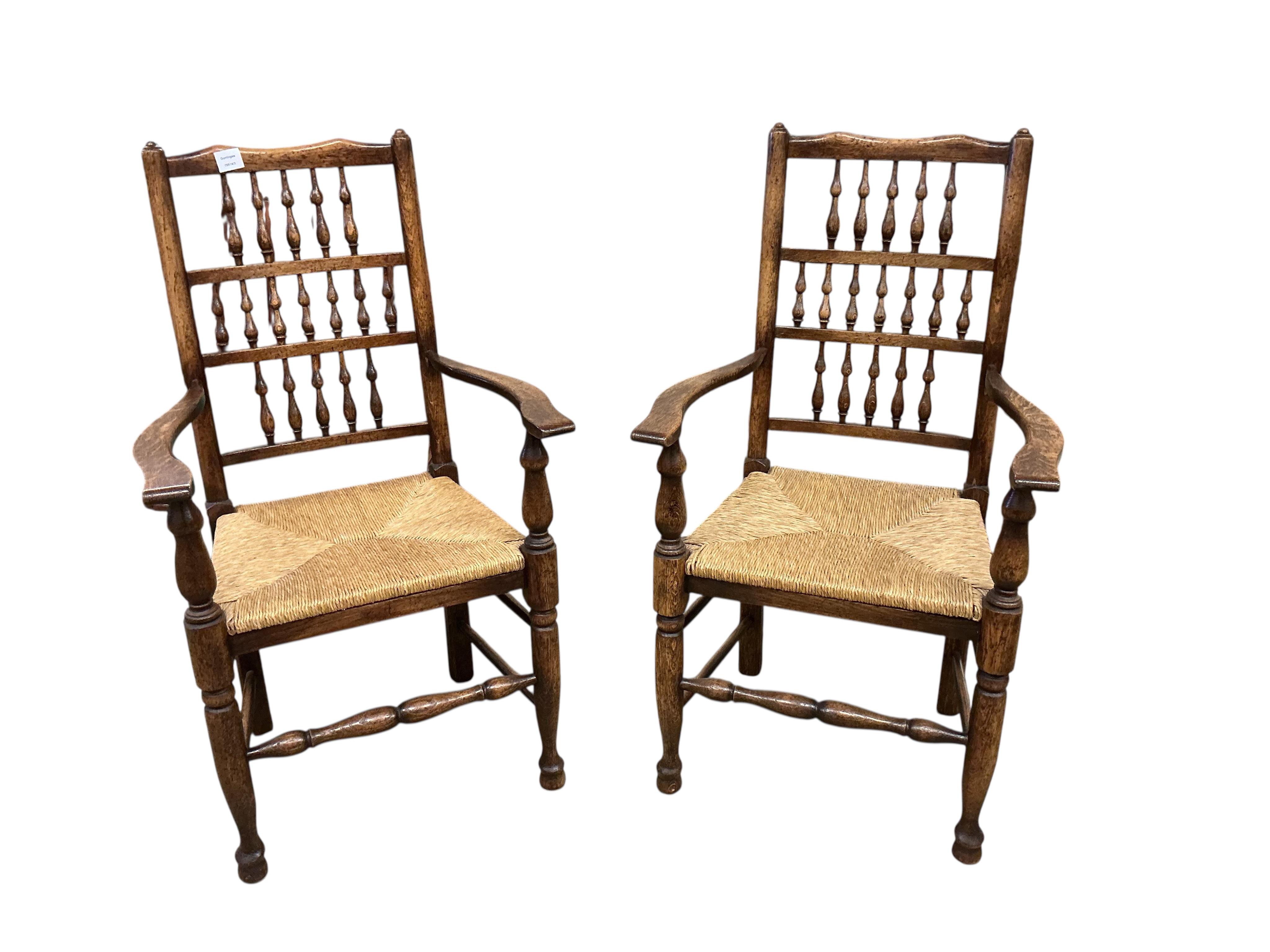 A set of ten Lancashire style ash and beech rush seat spindle back dining chairs, two with arms